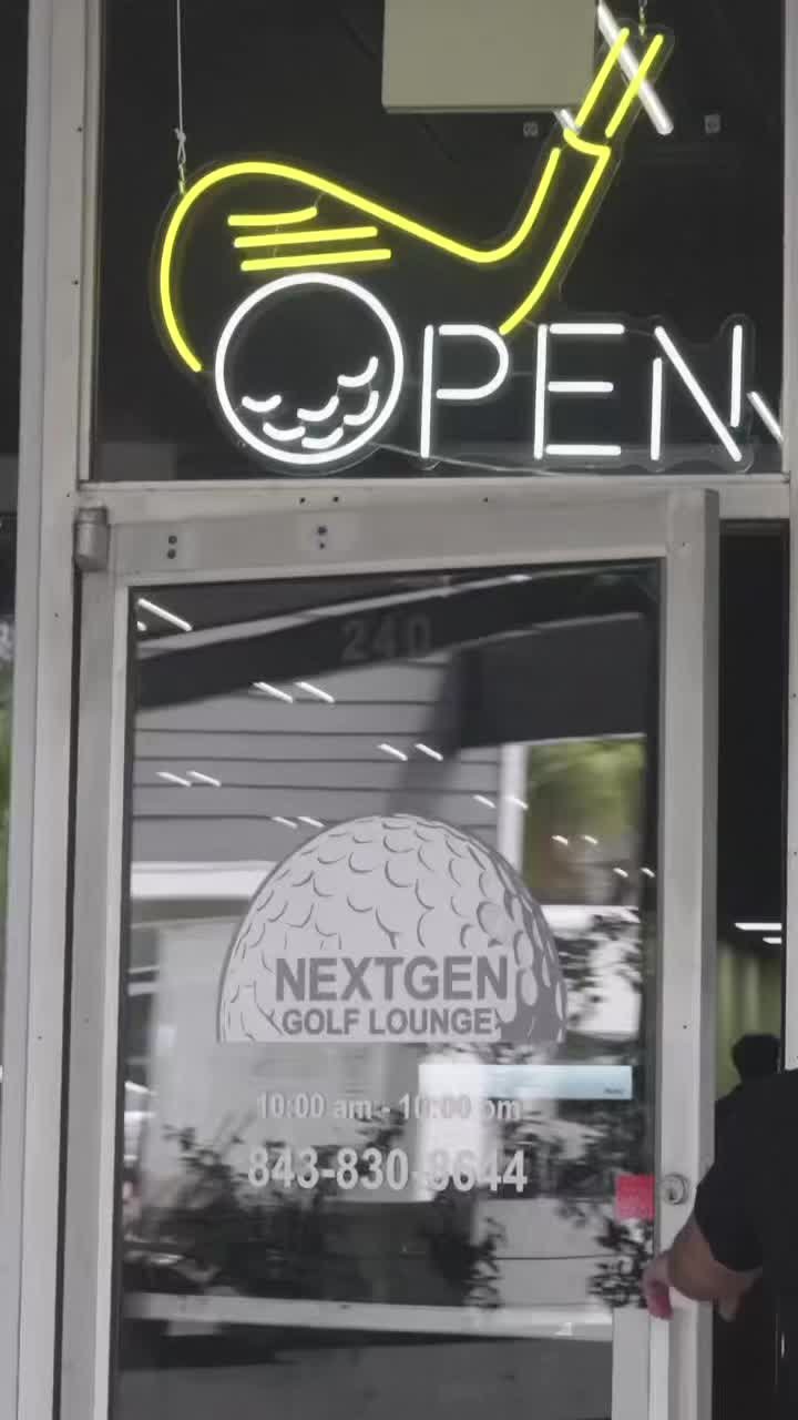 NextGen Golf Lounge entrance with its golf-themed open sign